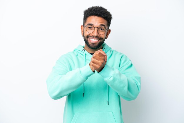 Young Brazilian man isolated on white background laughing