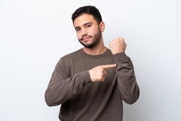 Young Brazilian man isolated on white background making the gesture of being late