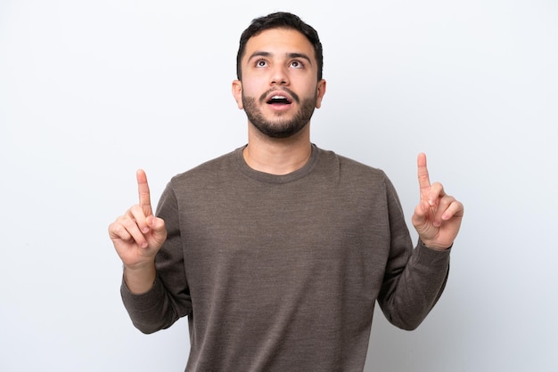 Young Brazilian man isolated on white background surprised and pointing up