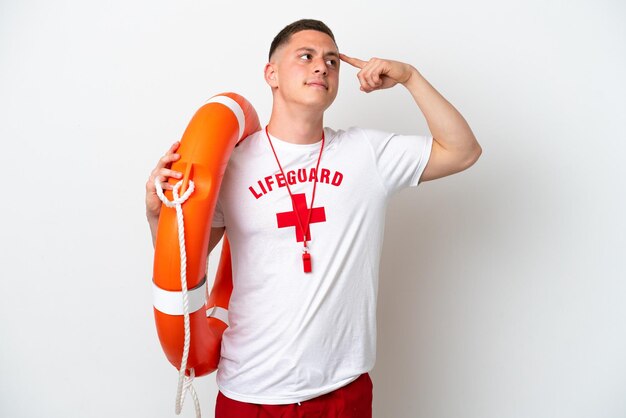 Young brazilian man isolated on white background with lifeguard equipment and having doubts with confuse face expression