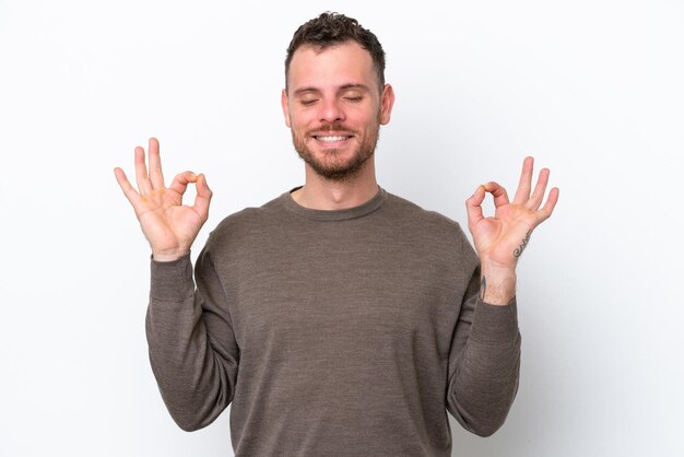 Young Brazilian man isolated on white background in zen pose