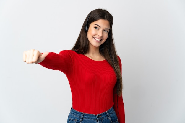 Young Brazilian telemarketer girl over isolated wall giving a thumbs up gesture