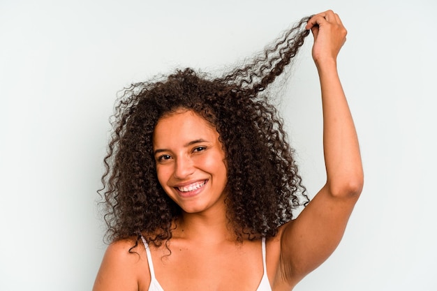 Young Brazilian woman isolated on blue background