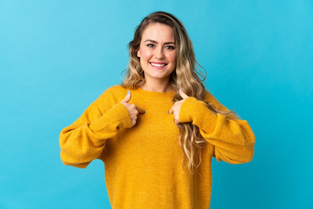 Young Brazilian woman isolated on blue with surprise facial expression