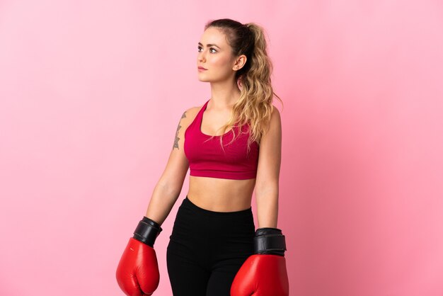 Young Brazilian woman isolated on pink with boxing gloves
