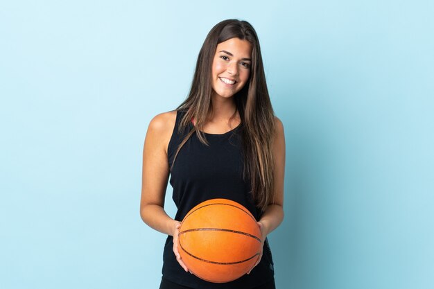 Young brazilian woman isolated playing basketball