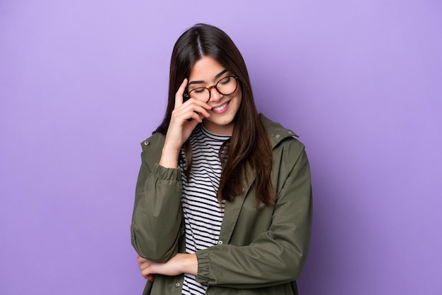 Young Brazilian woman isolated on purple background laughing