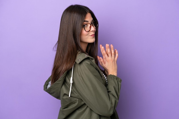 Young brazilian woman isolated on purple background scheming something