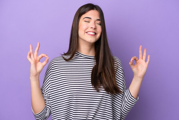 Photo young brazilian woman isolated on purple background in zen pose