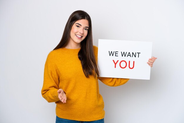 Young brazilian woman isolated on white background holding we want you board making a deal