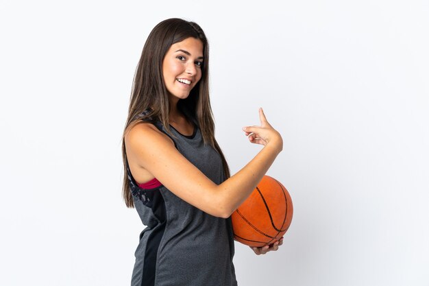 Young brazilian woman playing basketball isolated