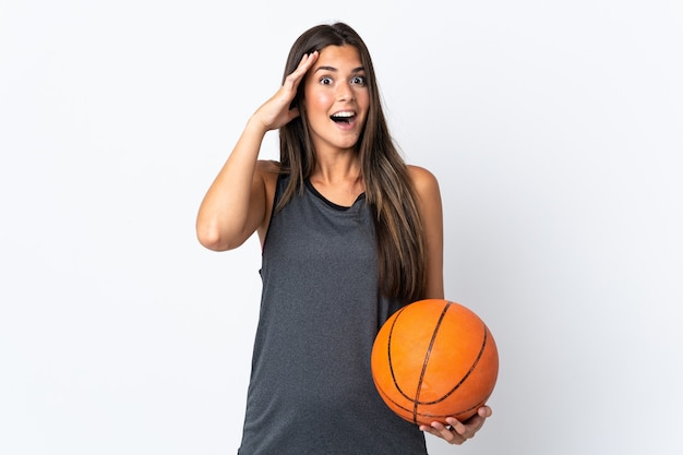 Young brazilian woman playing basketball isolated