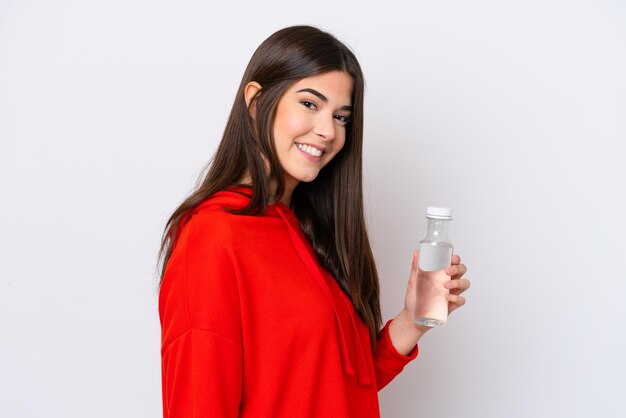 Young Brazilian woman with a bottle of water isolated on white background smiling a lot