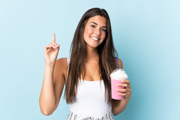 Young brazilian woman with strawberry milkshake isolated