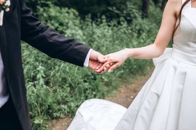 Young bride and groom holding hands