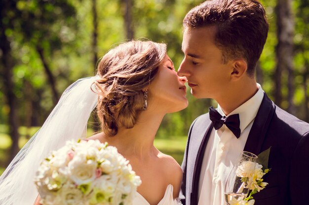 Young bride and groom kissing