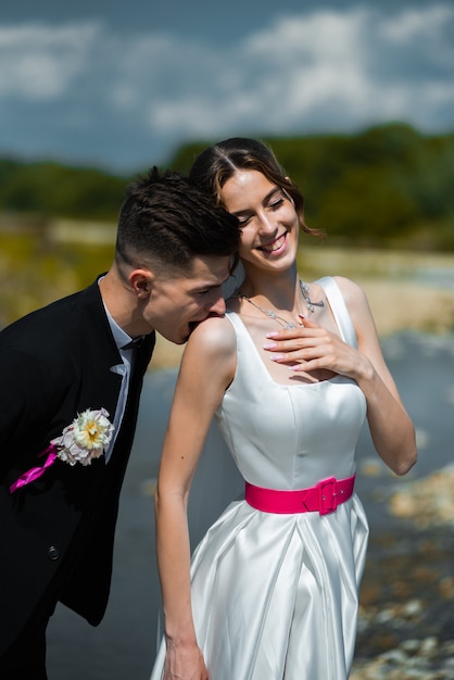 Young bride and groom outdoor walking Wedding day