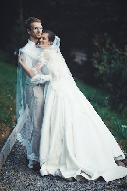 A young bride and groom standing together outdoor