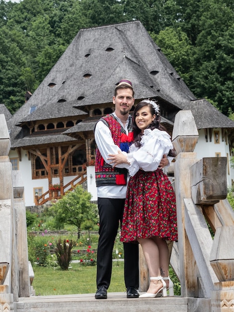 Young bride and groom wearing romanian traditional in Maramures Romania