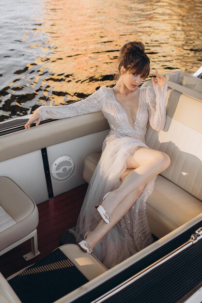 Young bride sitting on yacht