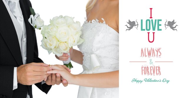 Young bridegroom putting on the wedding ring on his wifes finger against cute valentines message