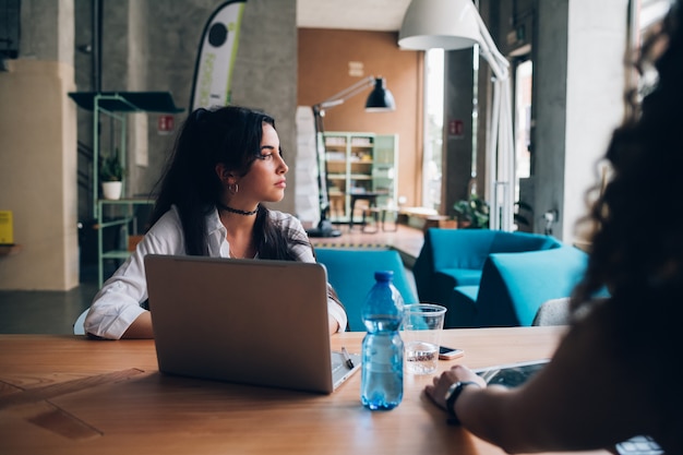 Young brunette businesswoman having meeting in modern loft