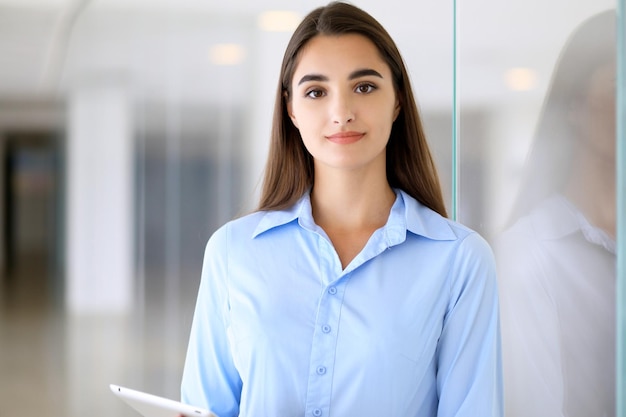 Young brunette businesswoman or student girl looking at camera