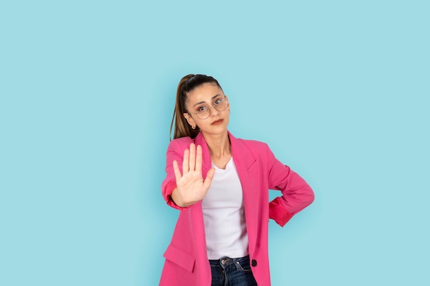 young brunette caucasian woman show open palm stop signs Angry serious business woman