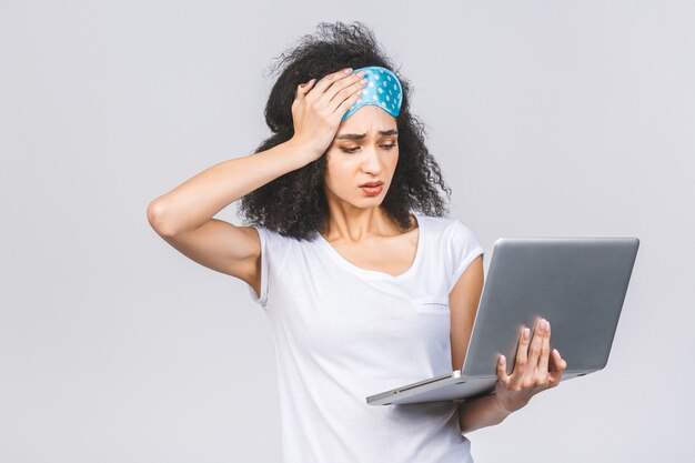 Young brunette curly woman with a sleeping mask