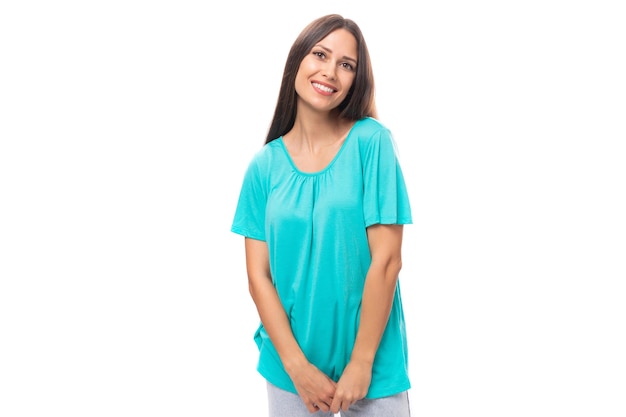 Young brunette european lady with straight hair dressed in blue tshirt isolated on white background