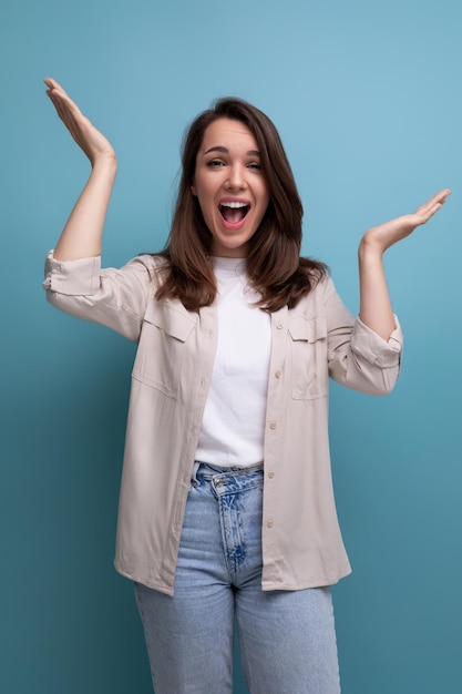 Young brunette female adult in casual shirt gesturing with her hands