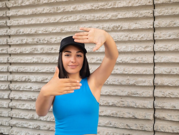 Young brunette gesturing hand frame