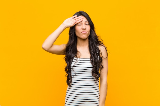 young brunette girl drying sweat off forehead