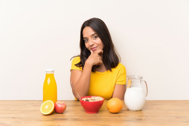 Young brunette girl having breakfast milk laughing