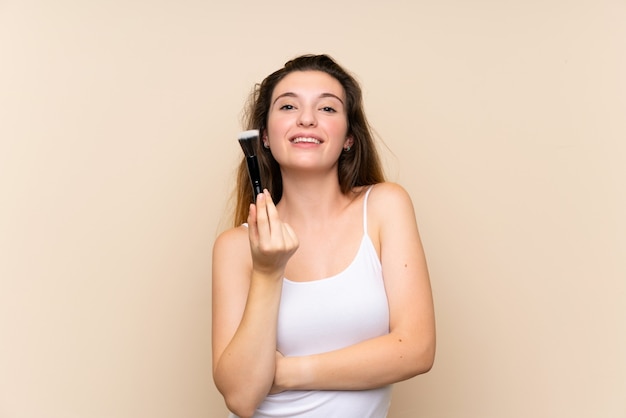 Young brunette girl over isolated wall