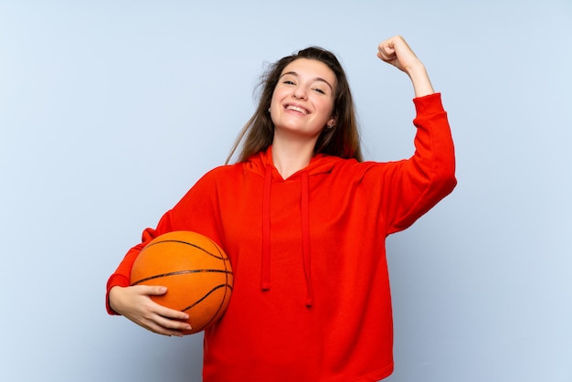 Young brunette girl with ball of basketball