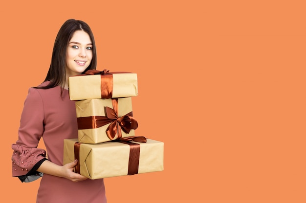 Young brunette girl with many gift boxes