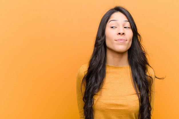 young brunette girl wondering and looking sideways