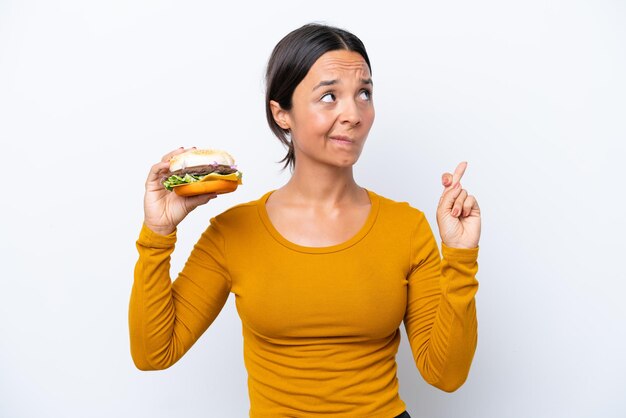 Young brunette hispanic woman on isolated background