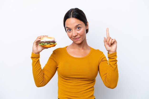 Young brunette hispanic woman on isolated background