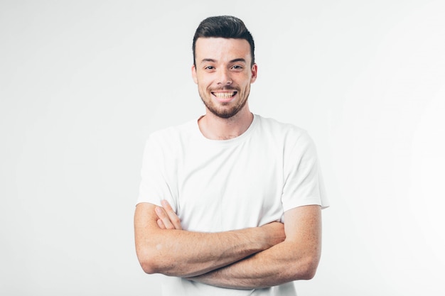 Young brunette man with beard dressed in white T-shirt