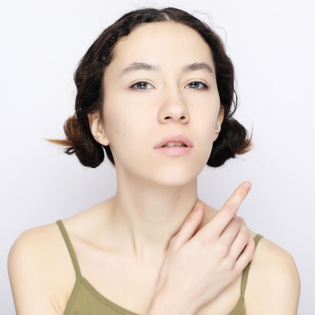 Young brunette model on a white background