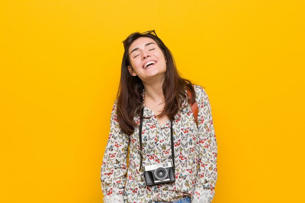 Young brunette traveler woman relaxed and happy laughing, neck stretched showing teeth.