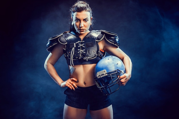 Photo young brunette wearing sexy uniform of rugby football player posing.