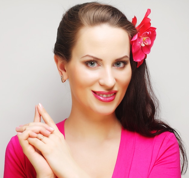 Young brunette with long hair in pink wear happy smiling