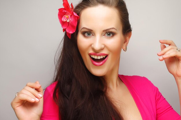 Young brunette with long hair in pink wear happy smiling