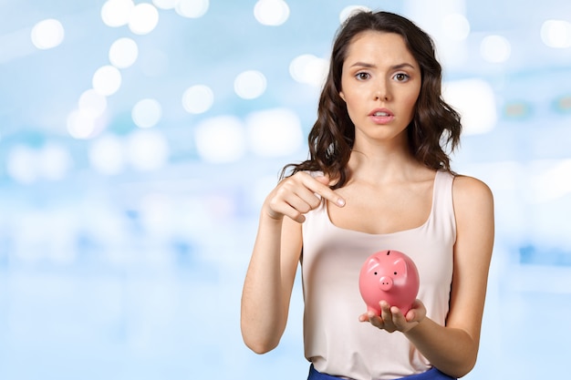 Young brunette with piggy bank.