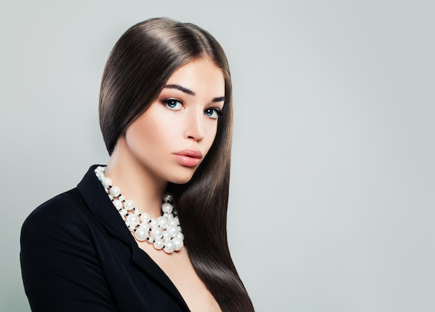 Young Brunette Woman in Black Suit on Banner Background