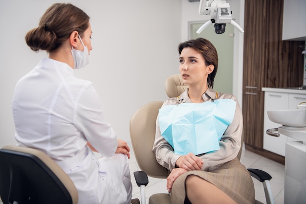 Young brunette woman on a check up at the dentistry office