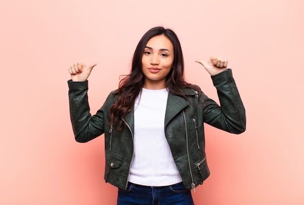 young brunette woman confident looking pointing to self